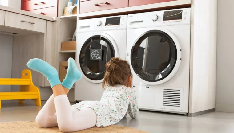 matratzenbezug waschen waschmaschine matratzenschoner trockner kind sitzt vor zwei waschmaschinen