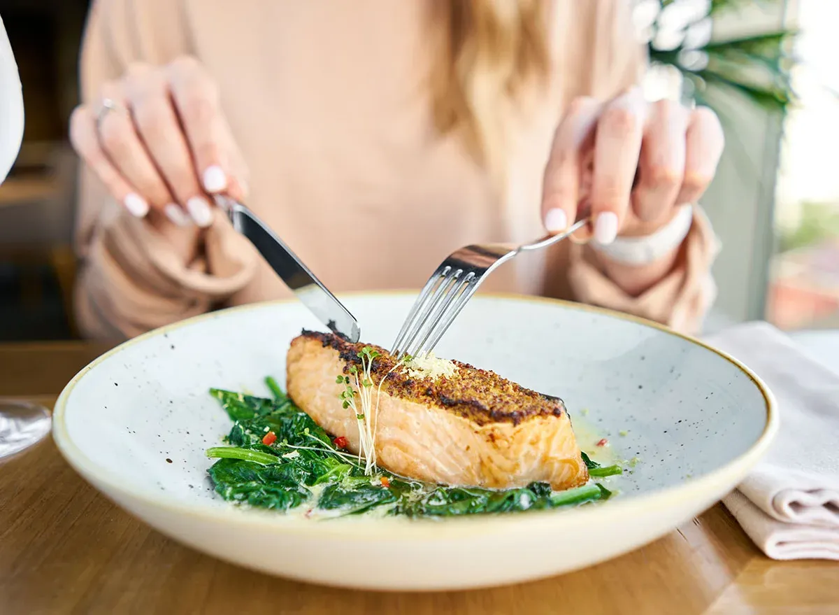proteinreiche lebensmittel konsumieren fisch mit grünsalat