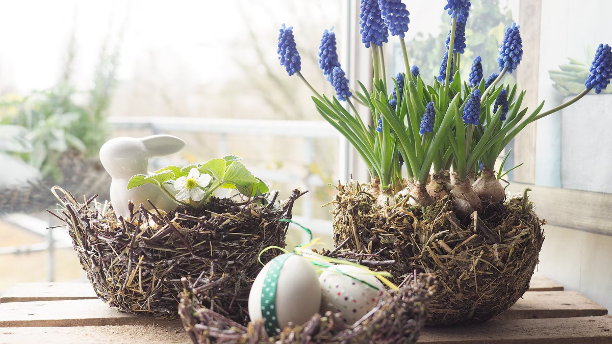 zwei osterzweige blätter und dekoration für ein osternest mit blumen und eiern