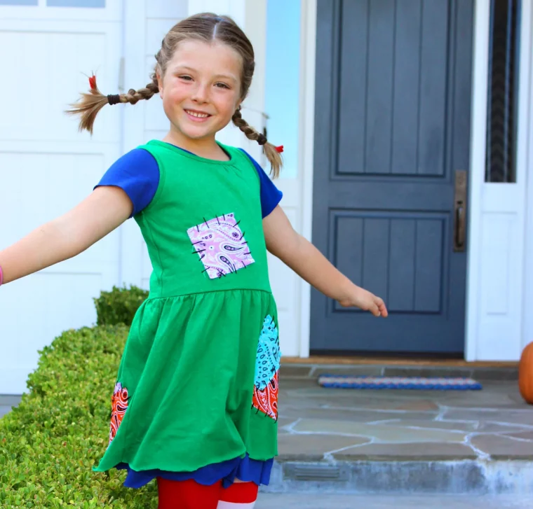 mädchen mit grünem kleid und zöpfen als pippi langstrumpf verkleidet