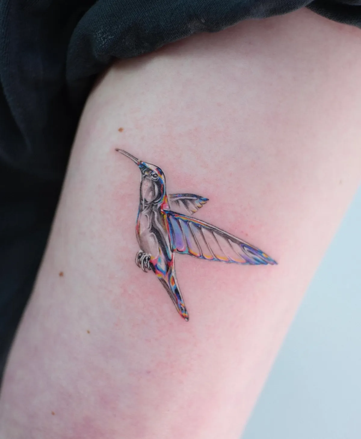 kolibri tattoo am oberarm detailliertes motiv mit schattierungen