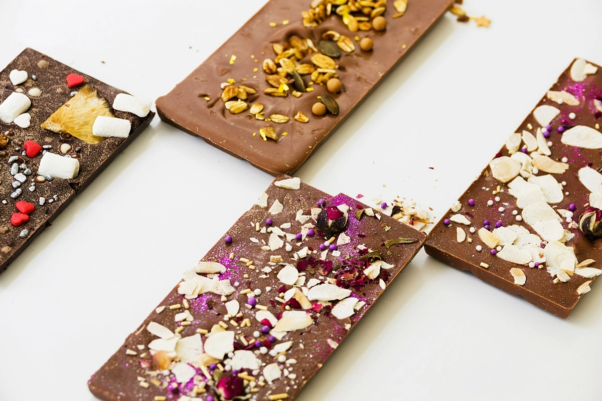 chocolate bars with different toppings white background