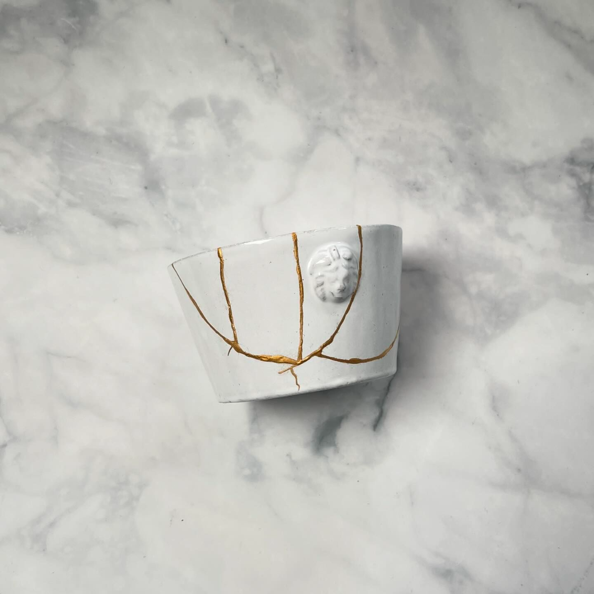 eine weiße teetasse mit kintsugi technik