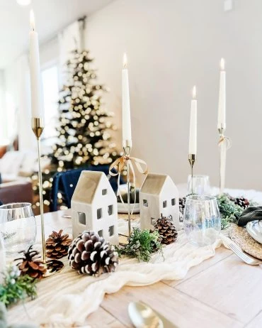 skandinavische weihnachtsdeko tisch festlich dekorieren mit kerzen und kleinen weisen haeuschen kenziemachome