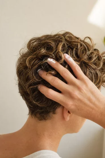 Lockiger Pixie Cut wird mit Lockencreme in Form gebracht